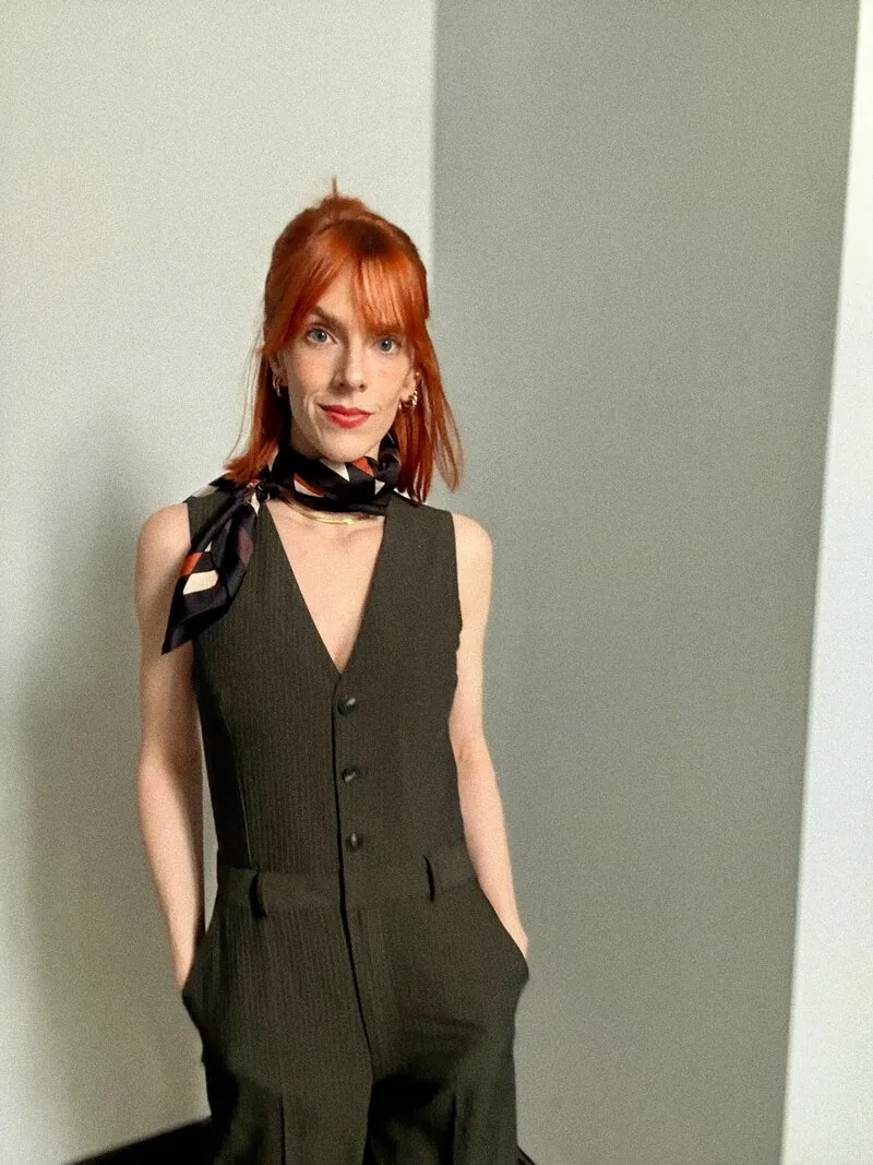 Rosie Rapp in a dark green waistcoat and silk scarf