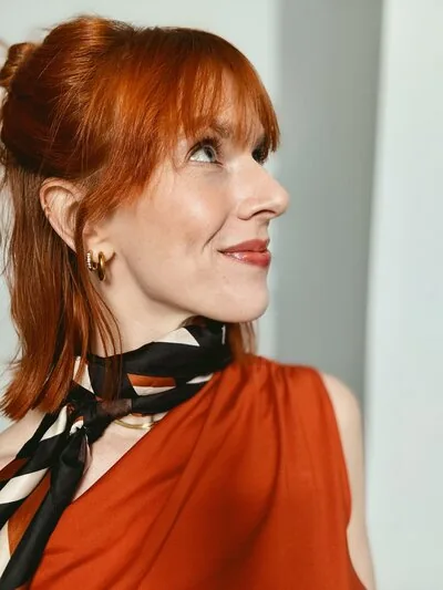 Rosie Rapp in a terracotta dress and silk neck scarf